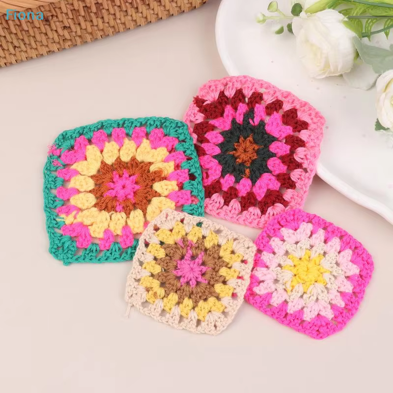 Deep-rose square crochet piece filling the frame against a warm camel backdrop